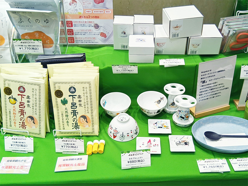 ゼルポティエの商品がクローズアップされた画像。淡いブルーの楕円形の皿に、黒いスプーンが置かれています。その奥には、緑とグレーのグラデーションが美しいカップや、白い小皿などが丁寧に並べられています。